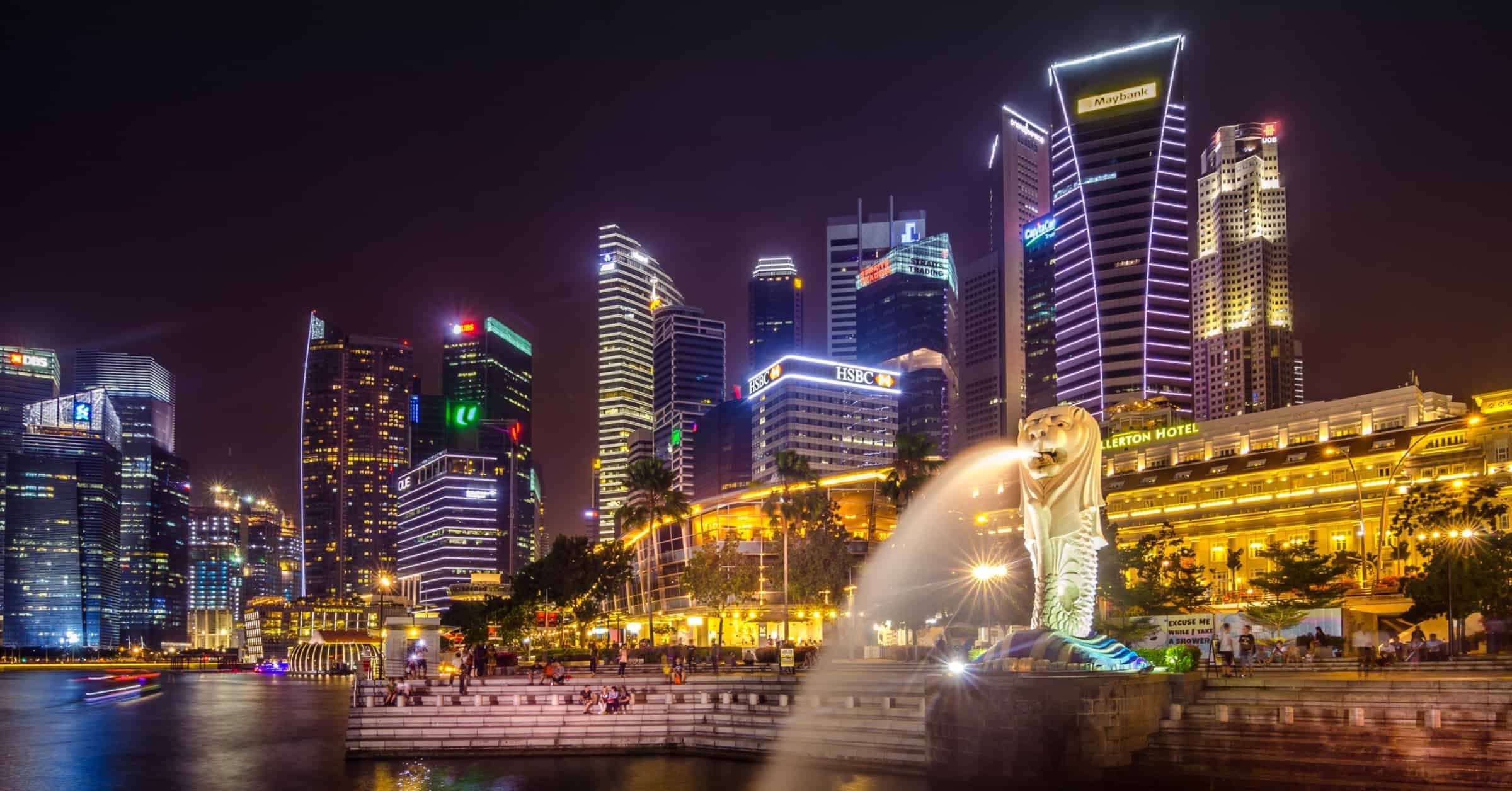 Experience the mesmerizing beauty of Singapore at night, where the captivating skyline showcases breathtaking skyscrapers and a charming fountain. Marvel at the stunning architecture while indulging in the luxurious hotels Singapore has to offer